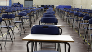 Image of an empty school examination hall in preparation for students to take an exam on a page for the benefits of Maths tuition